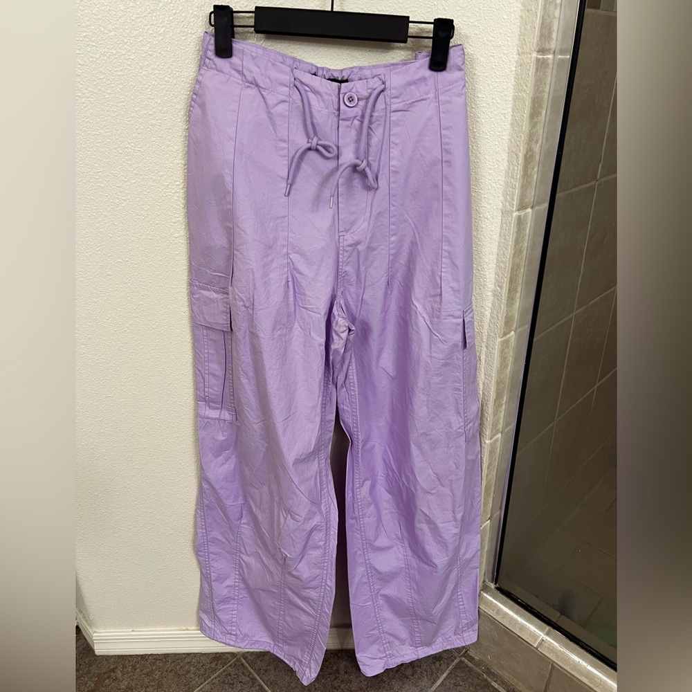 A pair of poplin cargo joggers featuring a toggle drawstring mid-rise waist